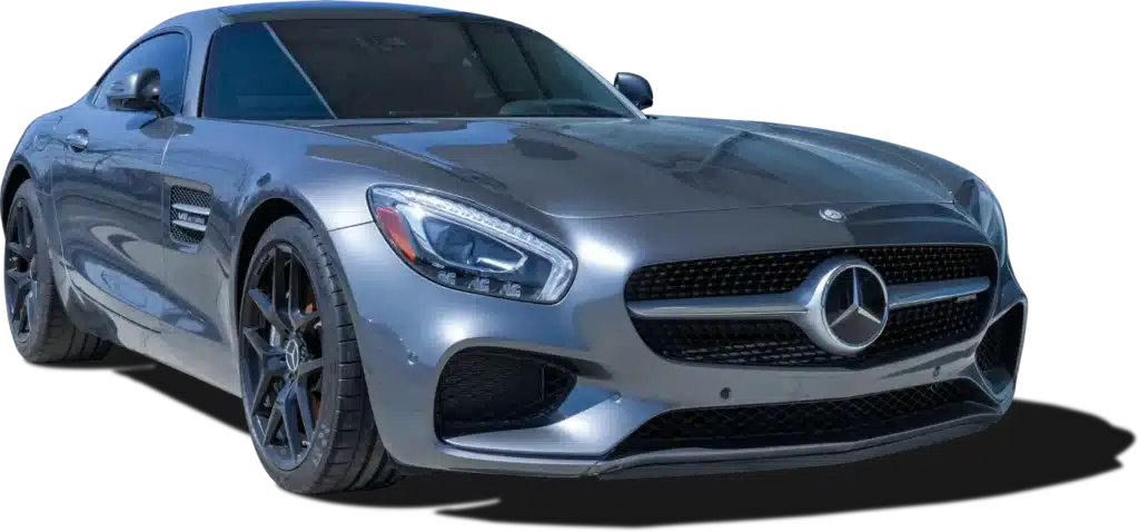 A sleek, silver sports car with a prominent front grille, large headlights, and black alloy wheels, shown against a plain, dark background.